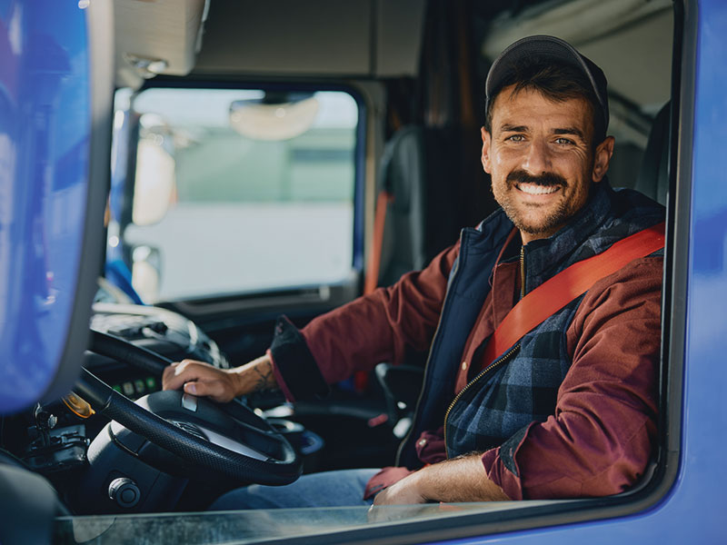 happy truck driver sitting in his truck