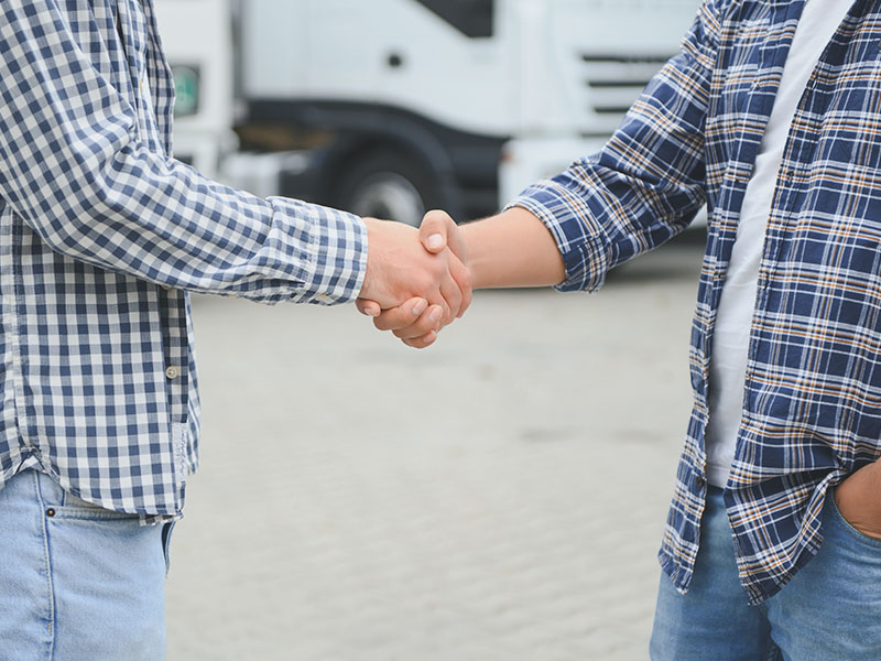 truck drivers shaking hands